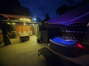 a patio with a jacuzzi tub in a backyard at night at Nicholas Apartment-Thuringer Wald in Tambach-Dietharz