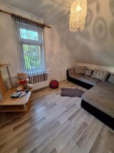 a living room with a teddy bear sitting on a table at Nicholas Apartment-Thuringer Wald in Tambach-Dietharz