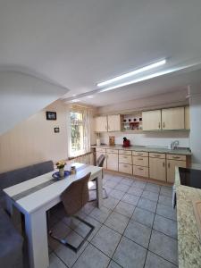 a kitchen with a table and a couch and a table at Nicholas Apartment-Thuringer Wald in Tambach-Dietharz