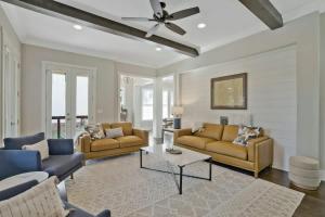 a living room with couches and a ceiling fan at Musician's Ranch in Franklin