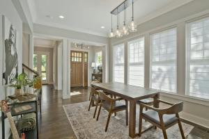 a dining room with a wooden table and chairs at Musician's Ranch in Franklin
