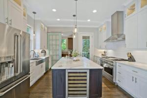 a large kitchen with white cabinets and a large island at Musician's Ranch in Franklin +30 photos