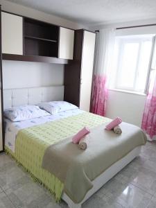 a bedroom with a bed with two towels on it at Apartments Sova By the Sea in Postira