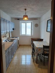 a kitchen with a table and a dining room at Apartments Sova By the Sea in Postira +11 photos