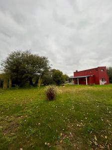a red barn in the middle of a field at Aurora - calle Del Sol in Santa Rosa