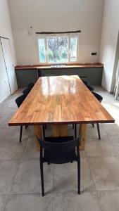 a large wooden table with chairs in a room at Aurora - calle Del Sol in Santa Rosa