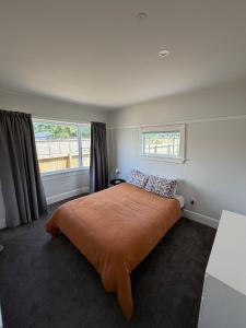 a bedroom with a large bed and a window at Green Views - Burkes Pass in Burkes Pass