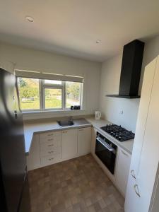 a kitchen with a sink and a stove top oven at Green Views - Burkes Pass in Burkes Pass