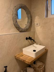 a bathroom with a white sink and a mirror at KUBIQ 2 Transalpina in Sebeş +15 photos