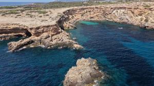 an aerial view of a beach with rocks and water at Apartament Glamour La Mata in Torrevieja