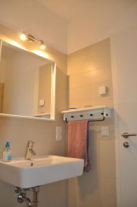 a bathroom with a sink and a mirror at Ferienhaus Wiekhus in Breege +13 photos