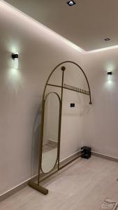a mirror in a room with a white wall at شاليه وقاعة ايليت in Buraydah +19 photos