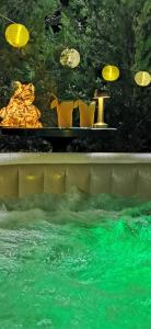 a pool of water with a table and yellow pitchers at Šum Apartmani - Stara planina in Crni Vrh