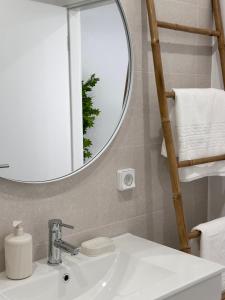 a bathroom with a sink and a mirror at Waves Madeira I in Caniçal +12 photos