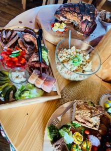 a wooden table topped with different types of food at Na Snozie in Milówka
