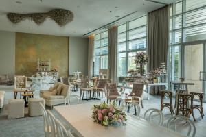 a large room with tables and chairs and windows at The St. Regis Mexico City in Mexico City
