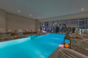 a hotel pool with chairs and a city skyline at The St. Regis Mexico City in Mexico City