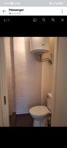 a bathroom with a white toilet in a room at Korter in Tartu