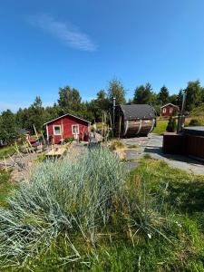 a yard with a red house and a boat at Örnen' in Undenäs