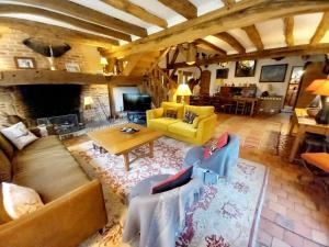 a living room with a couch and a table at Les Gordons in Chaumont-sur-Tharonne