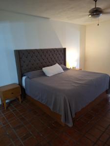a bedroom with a large bed with a pillow on it at Depa en planta baja con alberca in Puerto Vallarta