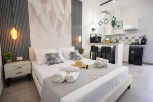 a bedroom with a large bed with towels on it at Esmeralda Guest House in Cinisi