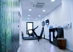 a gym with two tread machines and a treadmill at Sercotel Amistad Murcia in Murcia