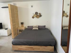 a bedroom with a large bed in a room at Soleya Apartment in Quartier de Lorient