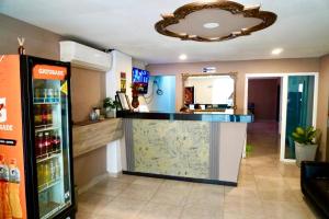 a kitchen with a counter and a refrigerator at HOTEL LUA ORIGENEs in Rodadero
