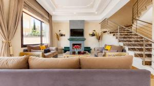 a living room with a couch and a fireplace at Villa Amroth in Marrakesh