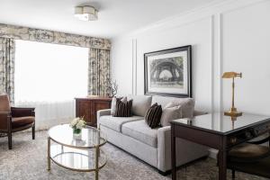 a living room with a couch and a table at Wedgewood Hotel & Spa - Relais & Chateaux in Vancouver