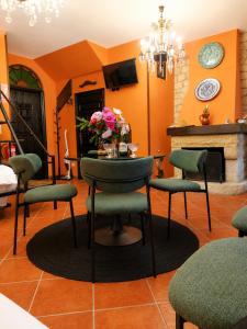 a room with a table and chairs and a fireplace at La Mío Quintana in Corao