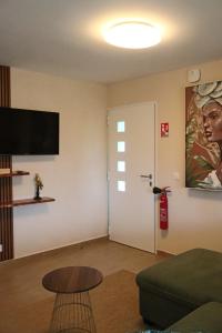 a living room with a couch and a door at Résidence Simona Premium in Deshaies