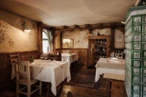 a restaurant with tables with white tablecloths at Locanda dei gentili in Ossana