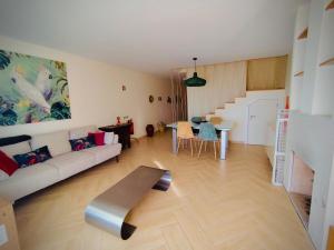 a living room with a couch and a table at Senhora da Rocha Sea View, Pool, Terrace in Porches