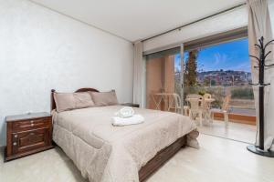 a bedroom with a bed and a large window at Waterfront apartment in Imiouadar in Agadir nʼ Aït Sa