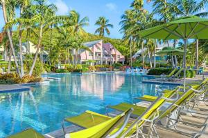 a pool at a resort with chairs and umbrellas at Margaritaville Vacation Club - St Thomas in Frydendal