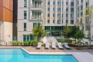 a swimming pool in front of a building at Luxury 2BR Apartment with Pool, Balcony & Parking in Cambridge