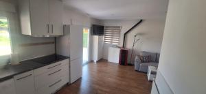 a kitchen with white cabinets and a living room at Casa Lyly in Quincoces de Yuso +16 photos