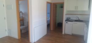 a kitchen with white cabinets and a sink and a toilet at Casa Lyly in Quincoces de Yuso