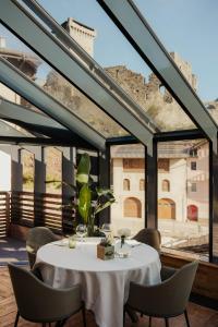 a dining room with a white table and chairs at Locanda dei gentili in Ossana