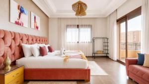 a bedroom with a large bed and a couch at Villa Amroth in Marrakesh +53 photos