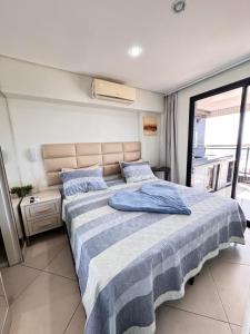 a bedroom with a large bed with blue pillows at Hotel Platinum - Landscape Luxo - in Fortaleza +285 photos
