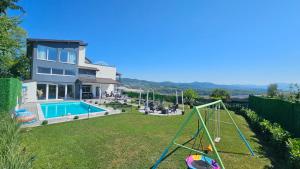 a backyard with a pool and a swing at Villa Kaplan Sarajevo in Gladno Polje