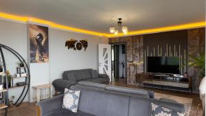 a living room with a couch and a television at cam teras villa in Cayeli
