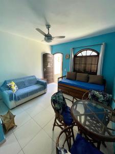 a bedroom with a bed and a table and chairs at Apartmento102 - Condomínio Brisa Mar in Cabo Frio