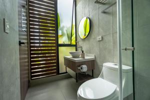 a bathroom with a toilet and a sink and a shower at Stella club & resort in Hacienda La Cabaña +28 photos
