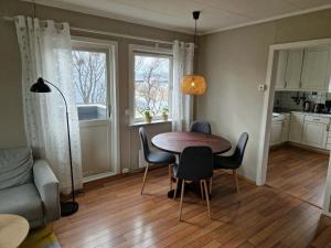 a kitchen and dining room with a table and chairs at Huset på øya in Vadsø