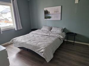 a bedroom with a bed and a window at Huset på øya in Vadsø
