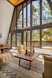 a living room with a table and a large window at Larks Nest in Big Bear Lake in Big Bear Lake